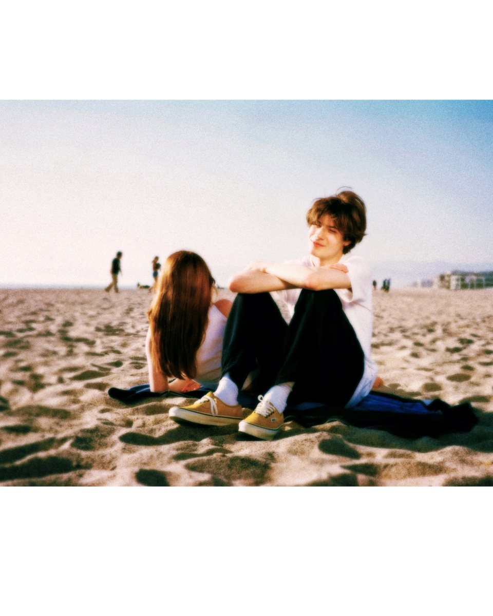 boy and girl sitting in the sand