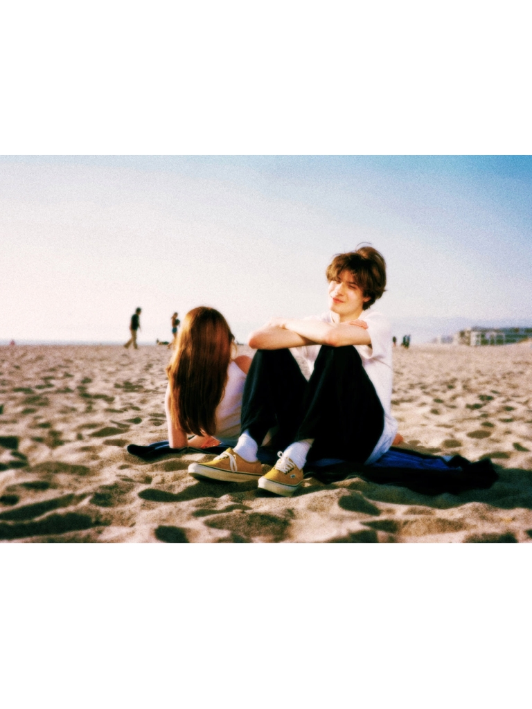 boy and girl sitting in the sand